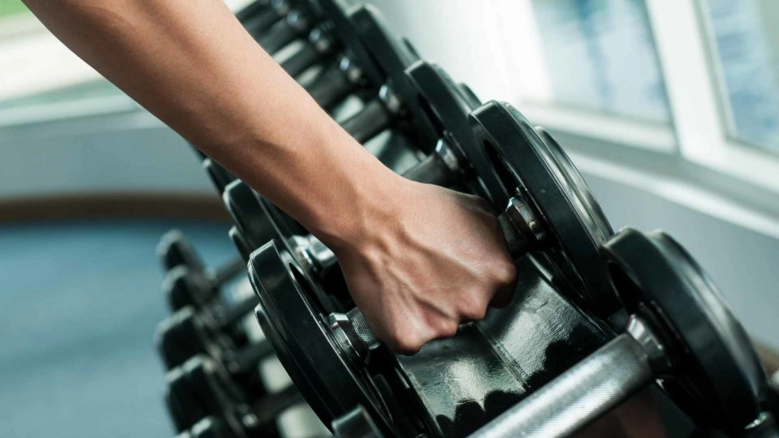 close up of person lifting a dumbell