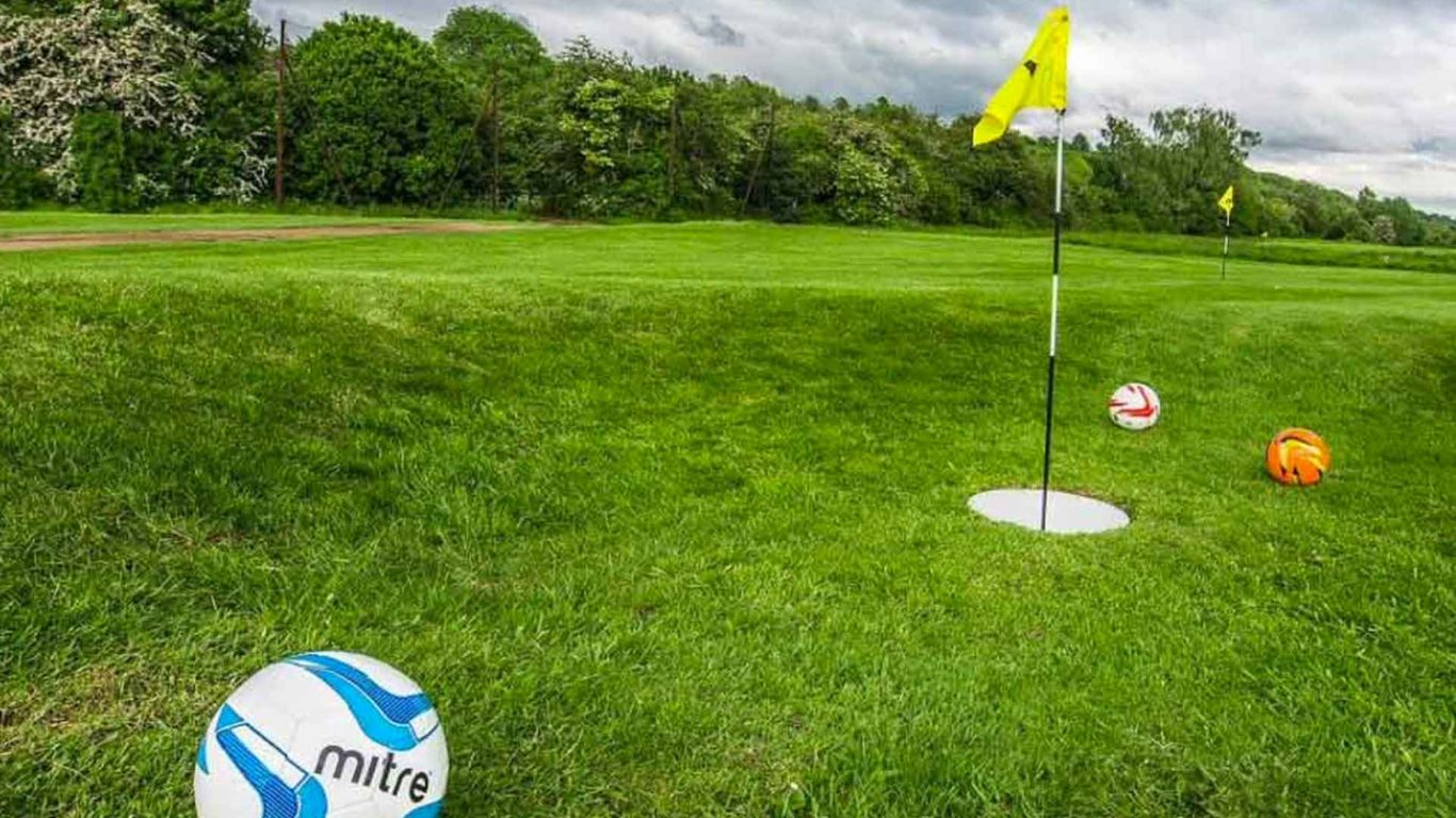 Green footgolf course with three footballs