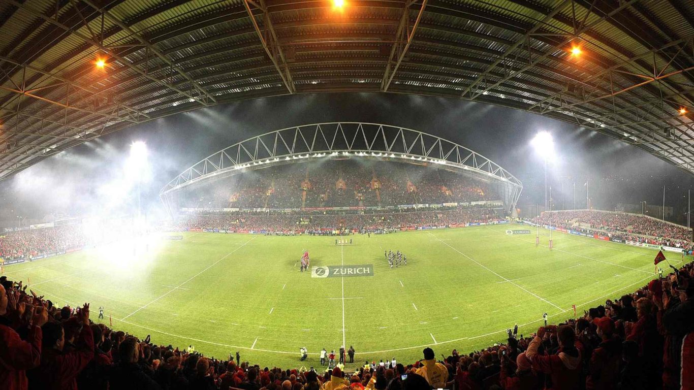 Panorama of Thomond Park stadium with spectators and two rugby teams on pitch